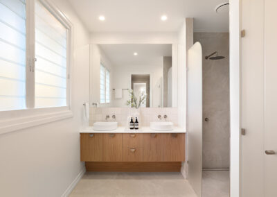 Double bathroom vanity in Grange with timber cabinetry, stone benchtop and modern fixtures