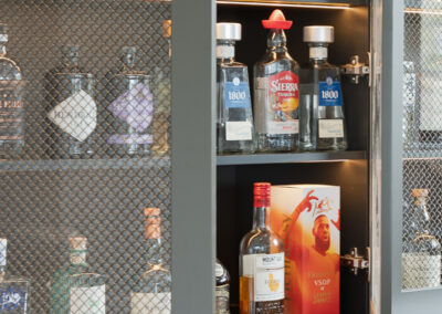 Open liquor cabinet with integrated LED lighting and mesh display doors