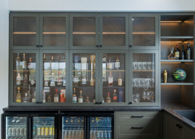 Custom bar cabinetry with mesh display doors, LED lighting and under-bench drink fridges