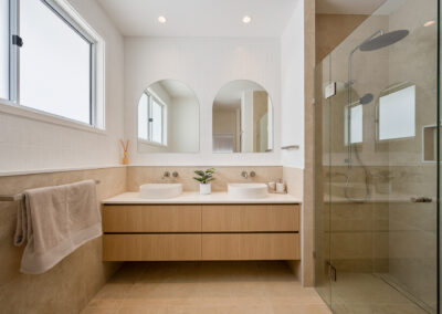 Bathroom vanity with arched mirrors, Laminex Aged Ash cabinetry and glass shower screen