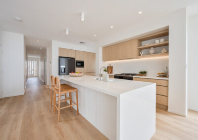 Custom kitchen with island bench, Laminex Aged Ash cabinetry, open shelving and integrated appliances